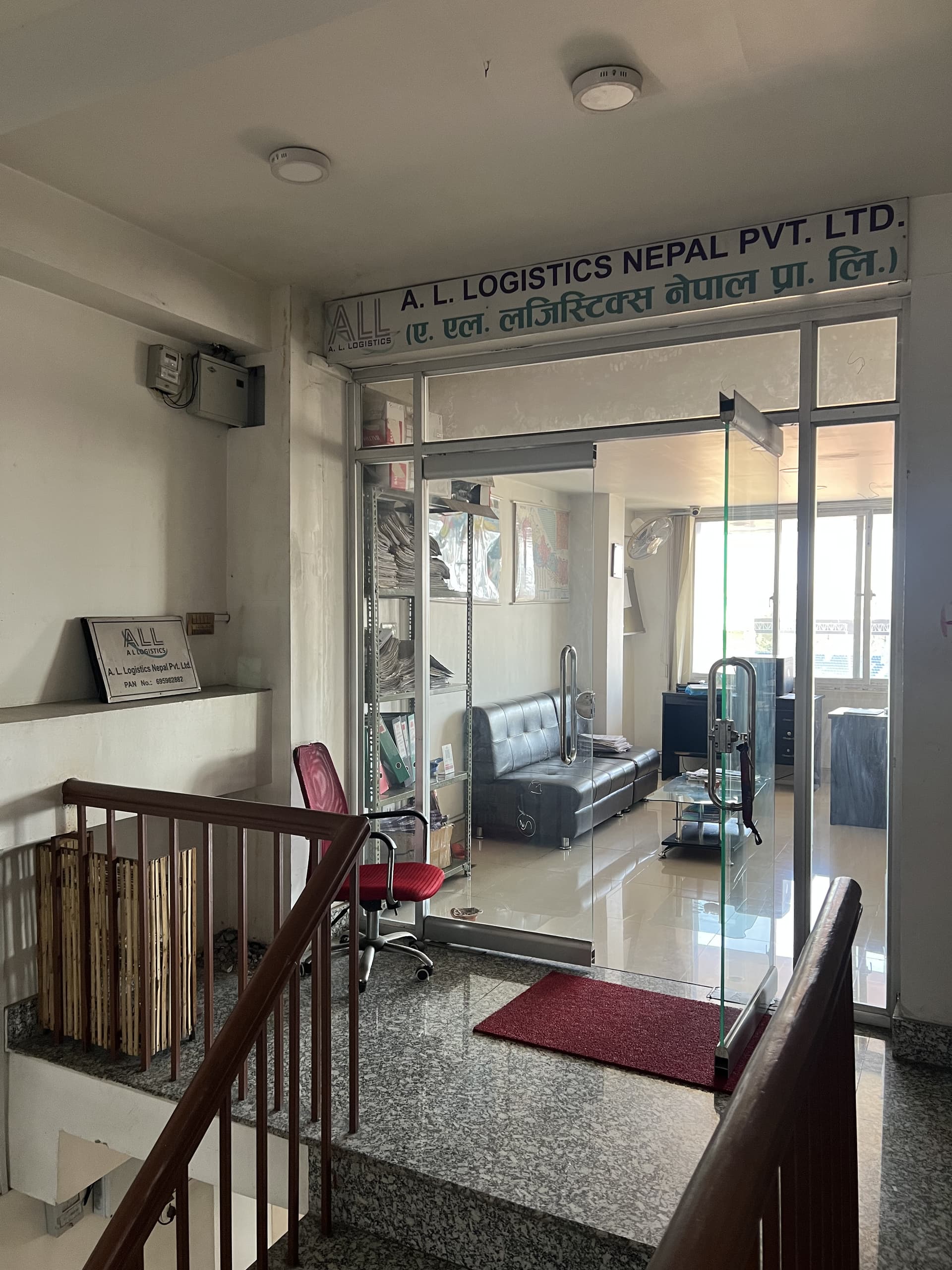 Office entrance with glass doors and company signage